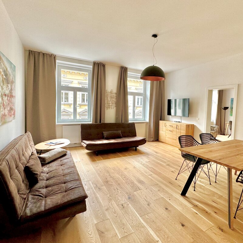 Bright living room with parquet & art: 2-room apartment for short-term rental, temporary housing for 1 to 6 months in Vienna