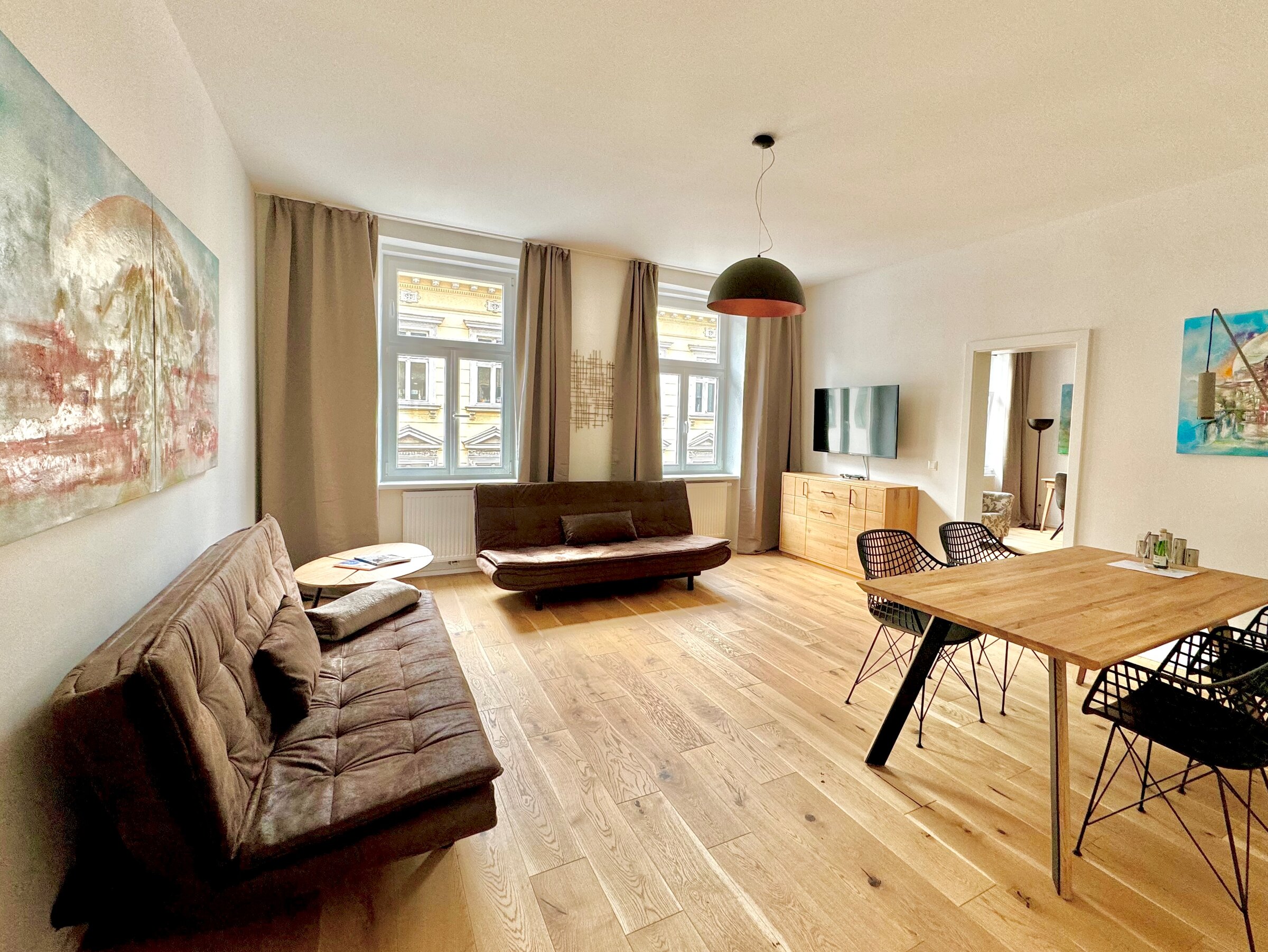 Bright living room with parquet & art: 2-room apartment for short-term rental, temporary housing for 1 to 6 months in Vienna