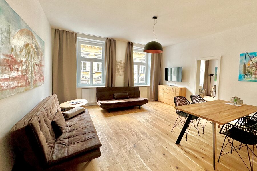 Bright living room with parquet & art: 2-room apartment for short-term rental, temporary housing for 1 to 6 months in Vienna