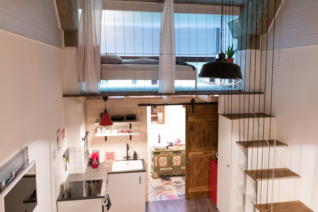 Open 1-room loft with sleeping gallery & wood details – short-term rental Villach, temporary housing for 1 to 6 months