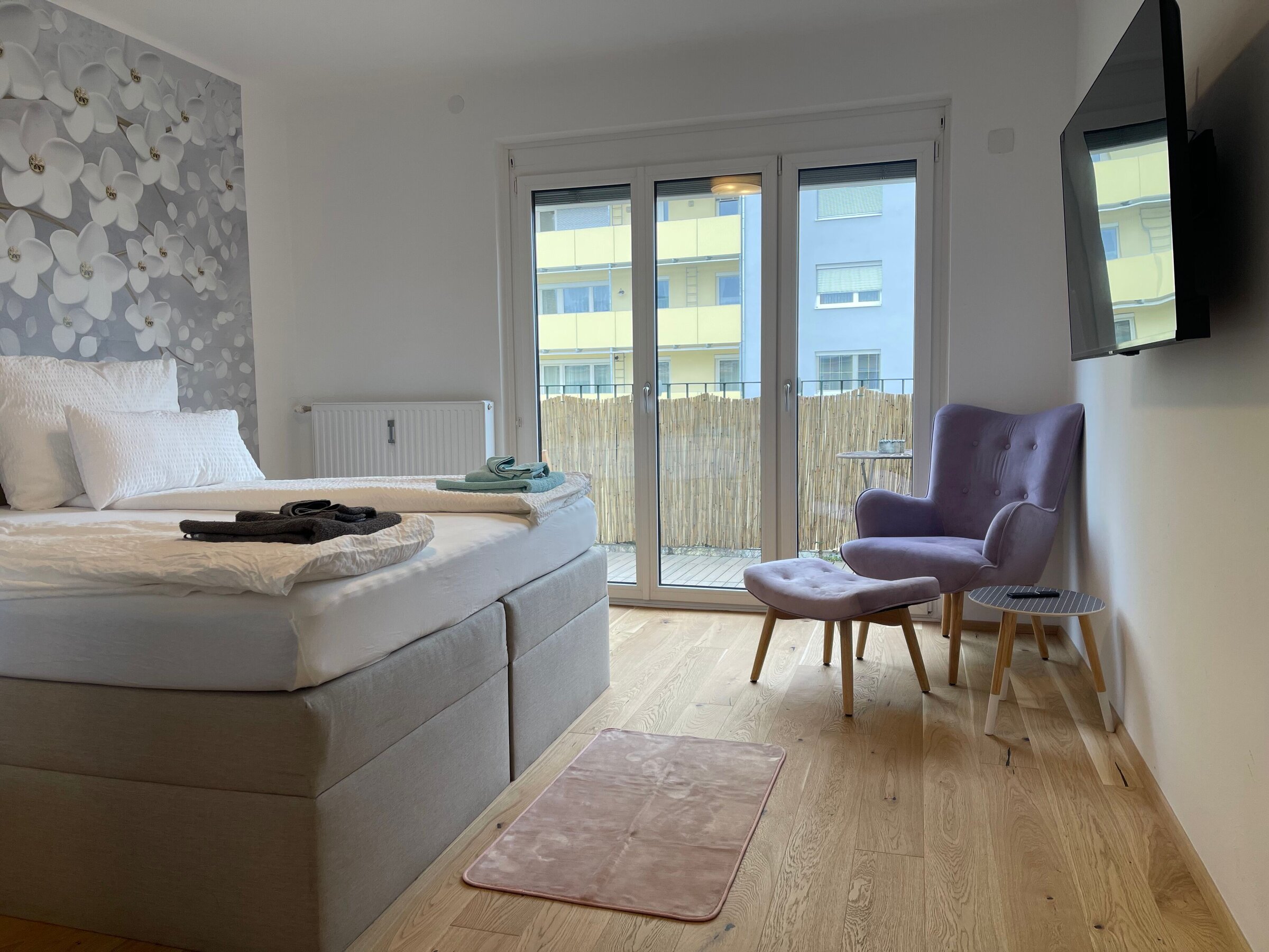 Spacious bedroom with attention to detail_Balcony_Smart TV_Relax armchair