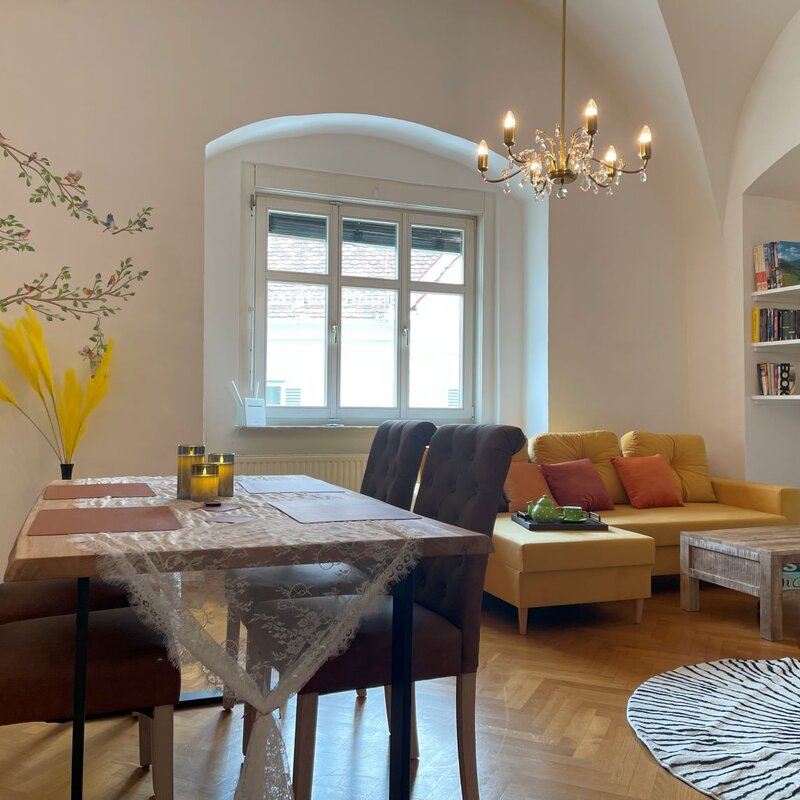 Beautiful large living-dining room with tiled stove and Smart TV