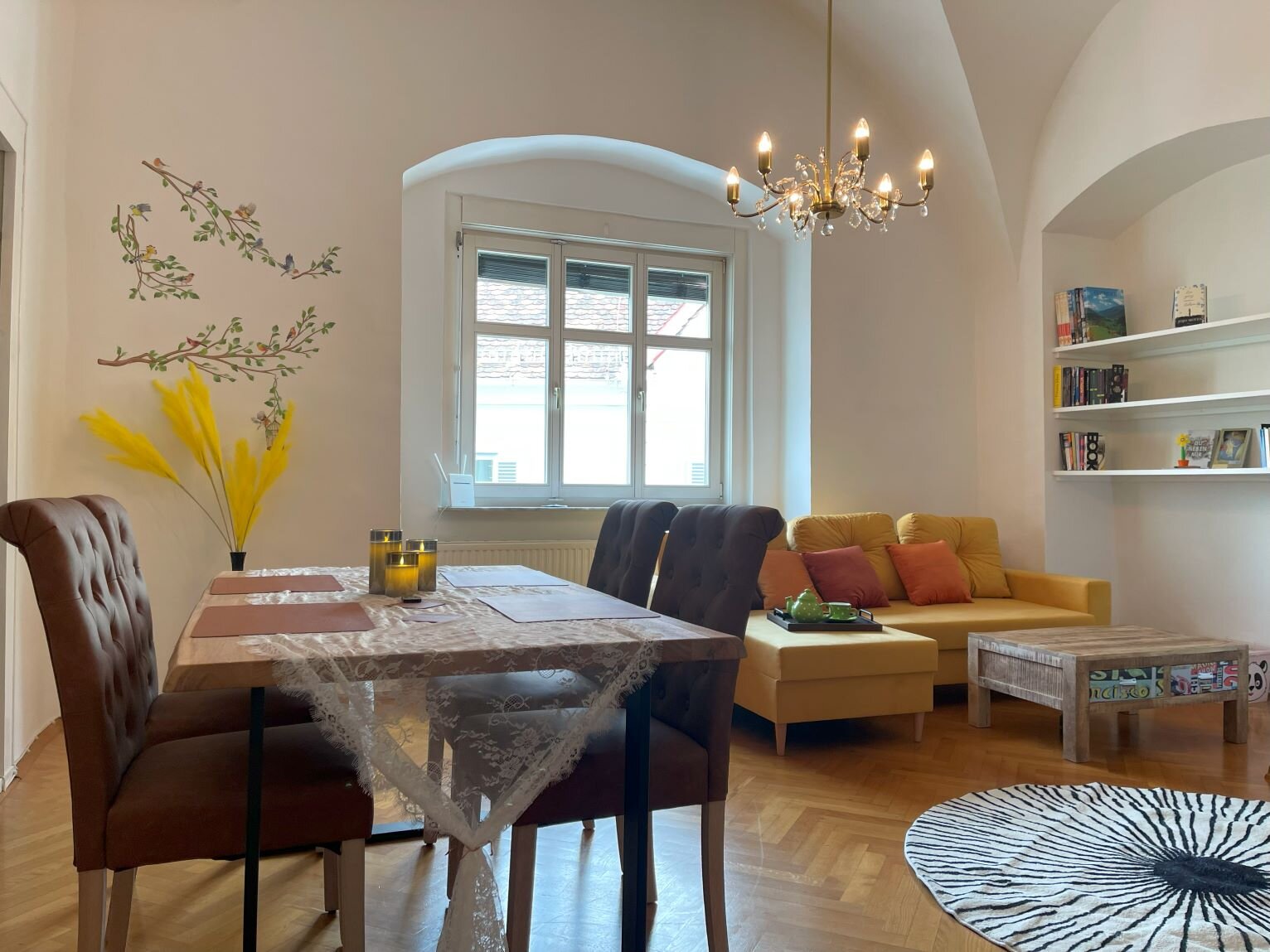 Beautiful large living-dining room with tiled stove and Smart TV