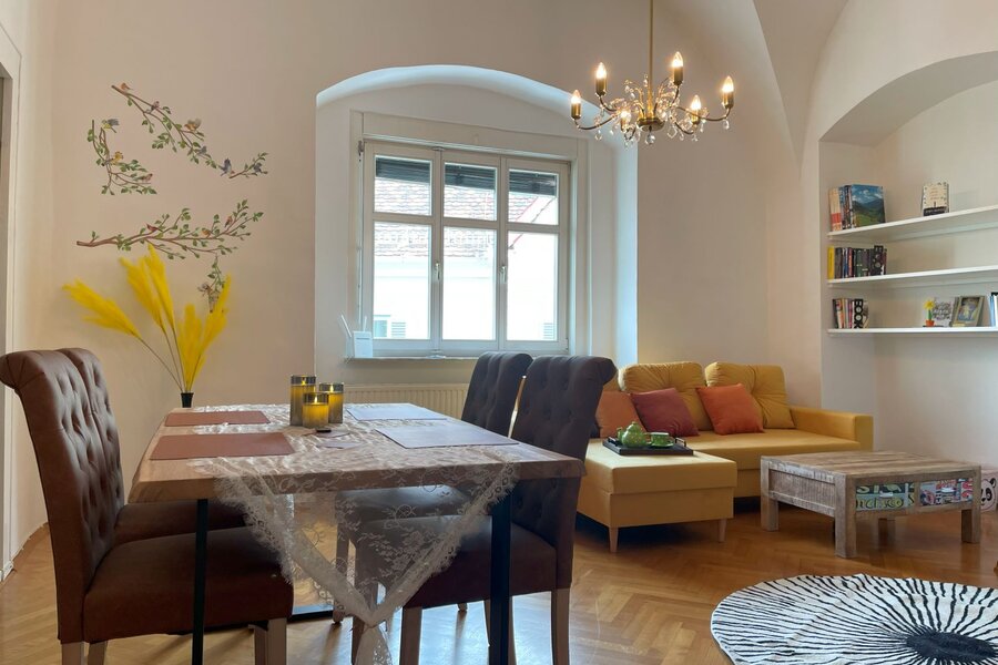 Beautiful large living-dining room with tiled stove and Smart TV