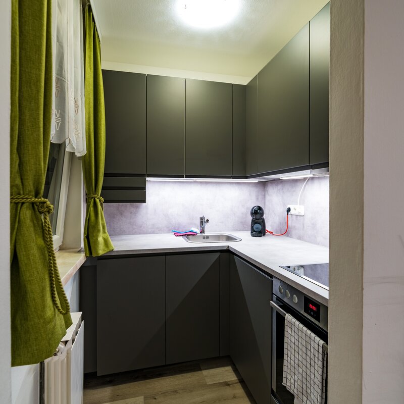 Compact kitchen with fridge, dishwasher, electric cooker, extractor fan and sink unit