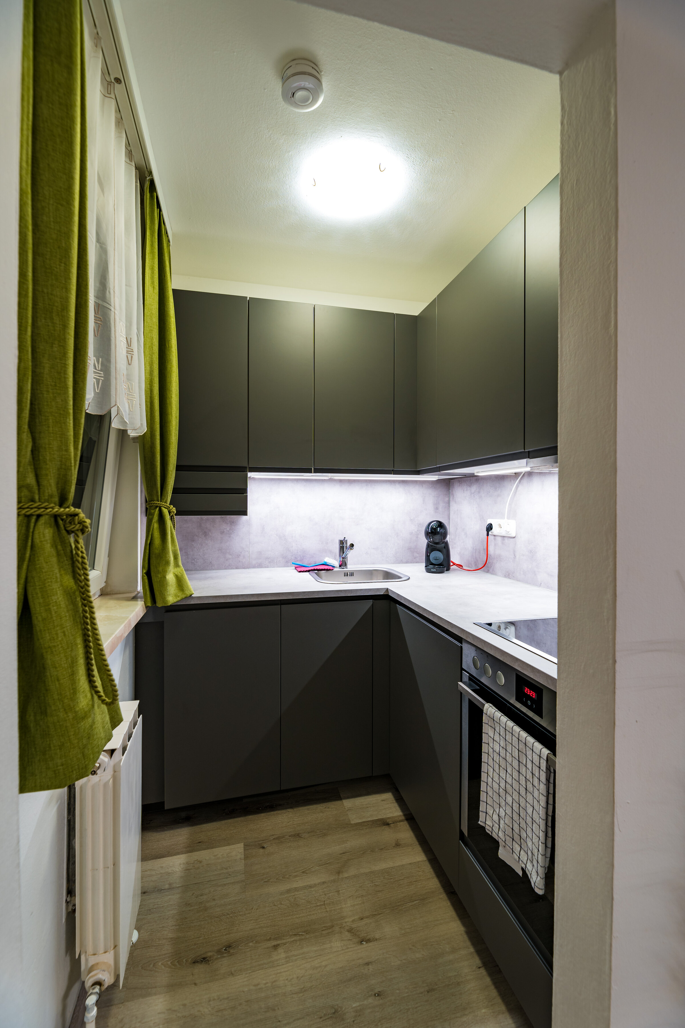 Compact kitchen with fridge, dishwasher, electric cooker, extractor fan and sink unit