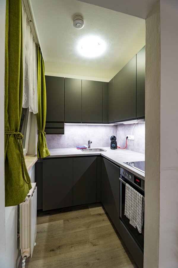 Compact kitchen with fridge, dishwasher, electric cooker, extractor fan and sink unit
