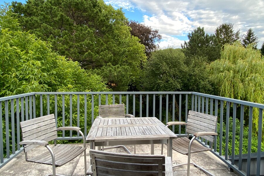 Balkon mit Ausblick auf den Garten mit wunderschönem alten Baumbestand