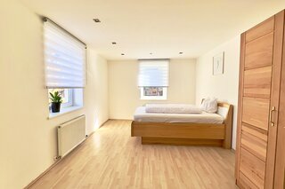 Helles Schlafzimmer mit Holzbett & Parkettboden – 4-Zimmer Wohnung Kurzzeitmiete Innsbruck, Wohnen auf Zeit 1–6 Monate