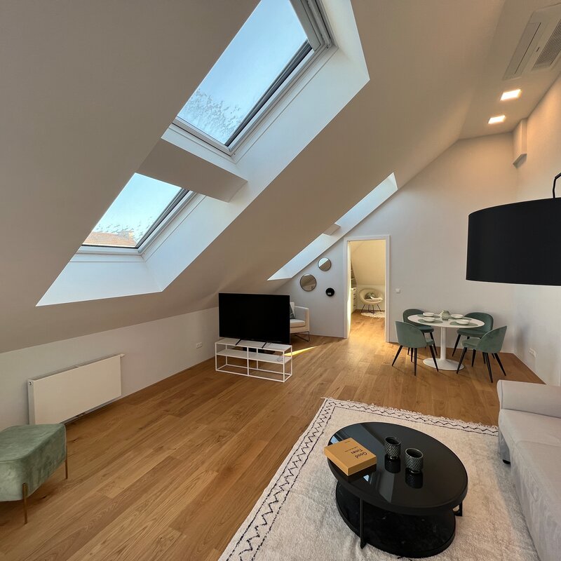 Helles DG-Wohnzimmer mit Dachfenstern, 2-Zimmer Wohnung, Kurzzeitmiete & Wohnen auf Zeit für 1 bis 6 Monate in Wien