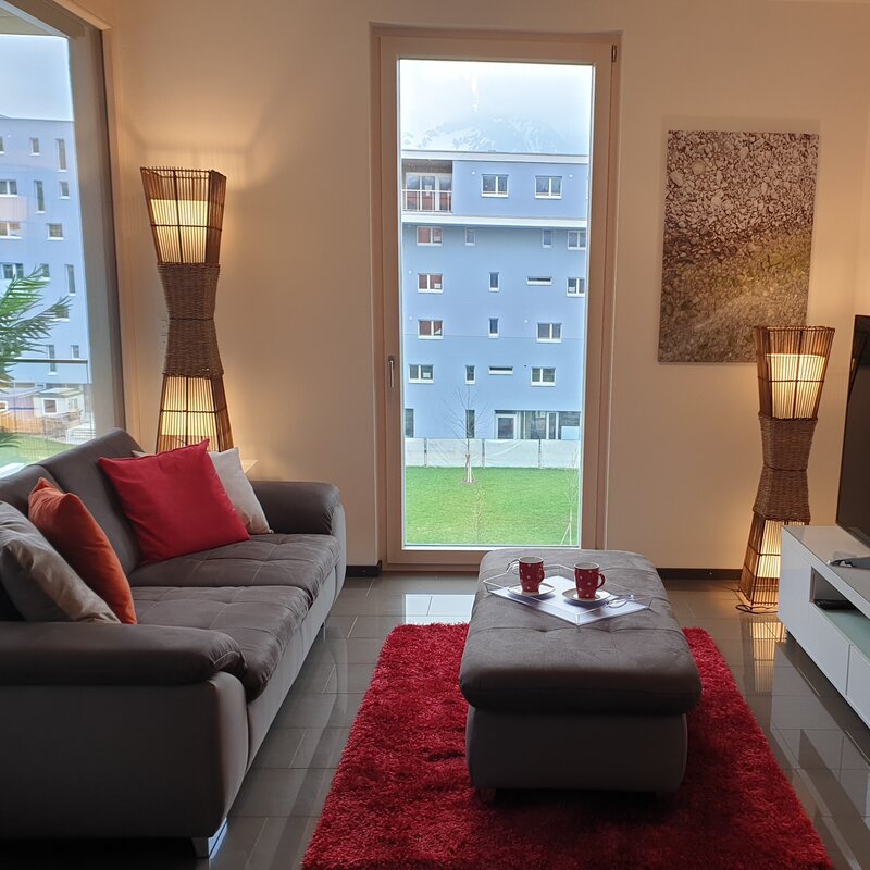 Bright living room with panoramic windows – 3-room apartment for short-term rental & temporary housing for 1 to 6 months in Salzburg