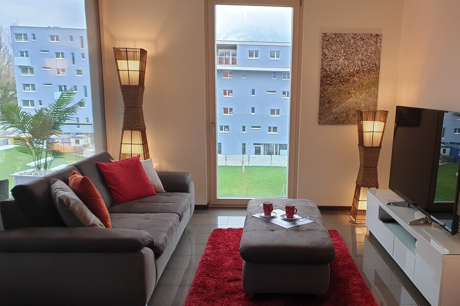 Bright living room with panoramic windows – 3-room apartment for short-term rental & temporary housing for 1 to 6 months in Salzburg