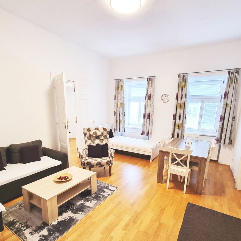 Bright living room with dining table & sofa – 3-room apartment, short-term rental, temporary housing 1 to 6 months, Vienna