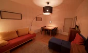 Living room with sofa bed and dining table
