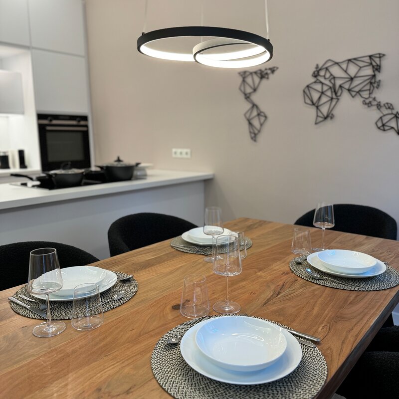 The stylish dining area seats four people and is perfect for shared meals and convivial evenings.