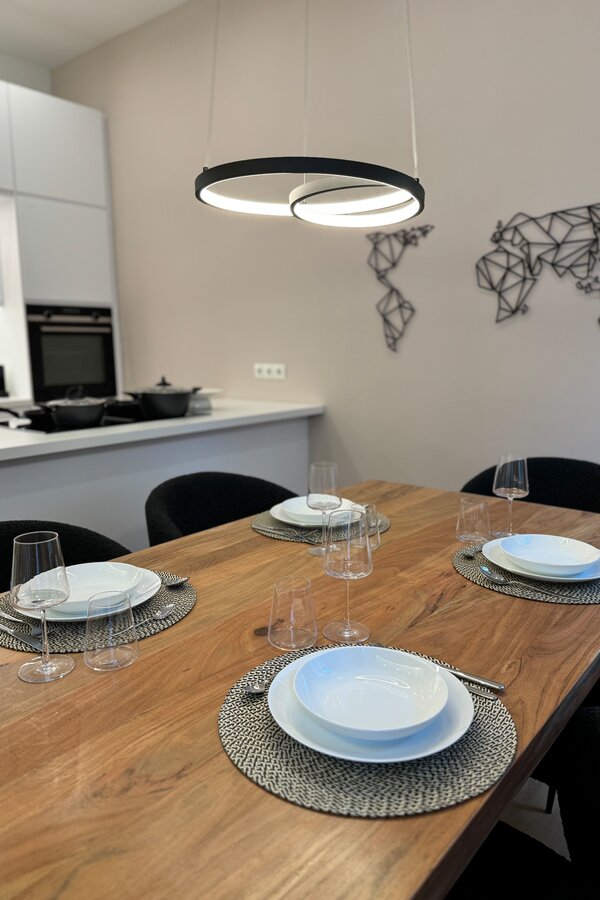 The stylish dining area seats four people and is perfect for shared meals and convivial evenings.