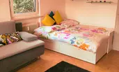 Living room with double bed and sofa