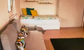 Living room with single bed and sofa