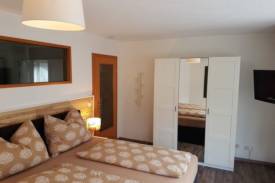 Box spring bed, wardrobe, TV