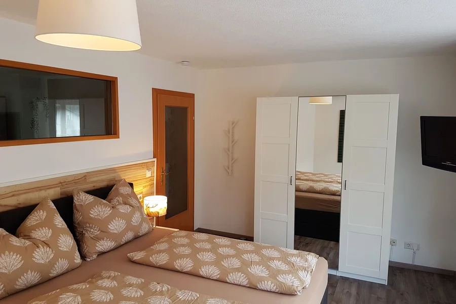 Box spring bed, wardrobe, TV