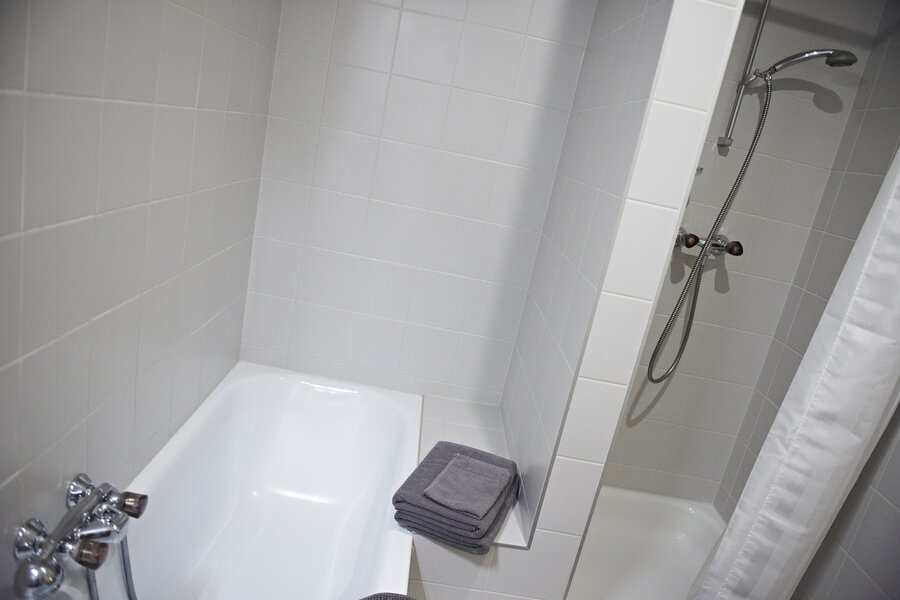 Badezimmer mit Badewanne und Dusche