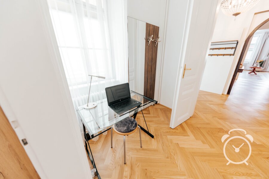Bright workspace with glass desk & laptop – 3-room apartment for short-term rental & temporary housing for 1 to 6 months in Vienna