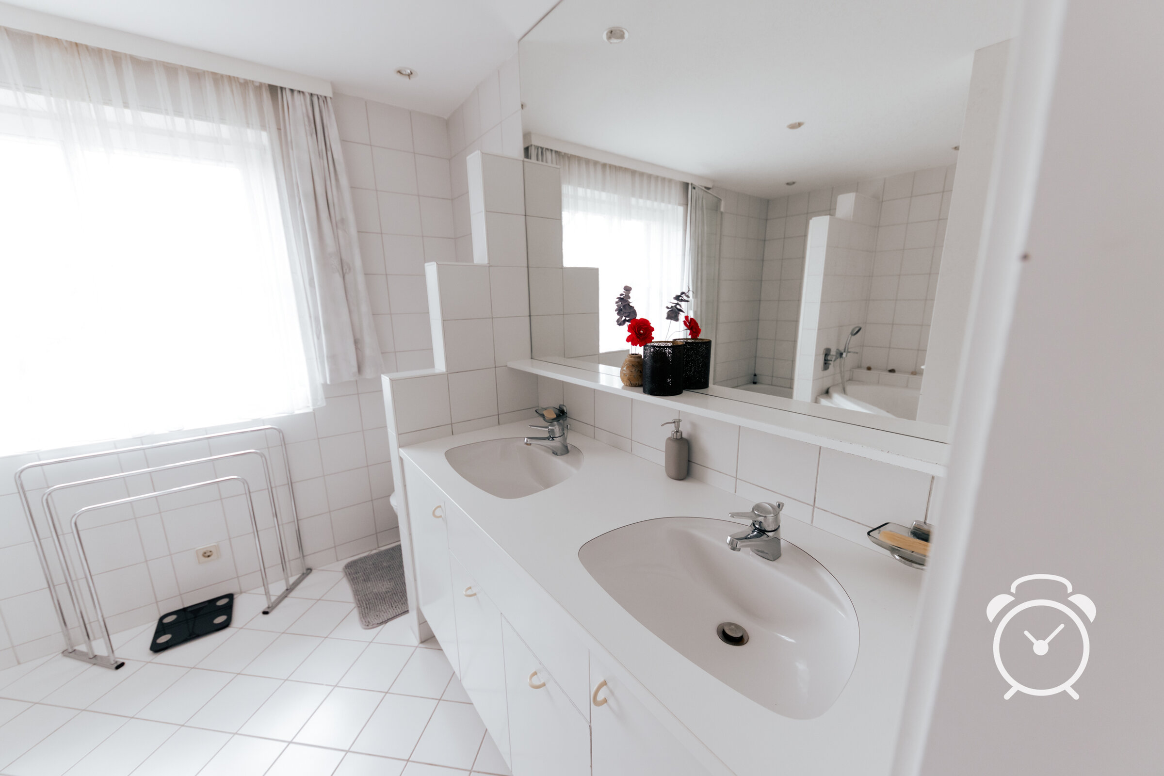 big bathroom with two sinks, big mirror, bathtub, shower and toilette