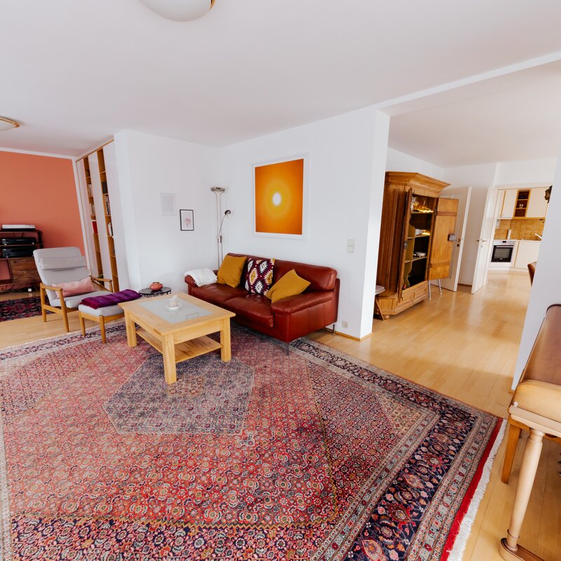 living room with sofa, playing area for kids and sound system