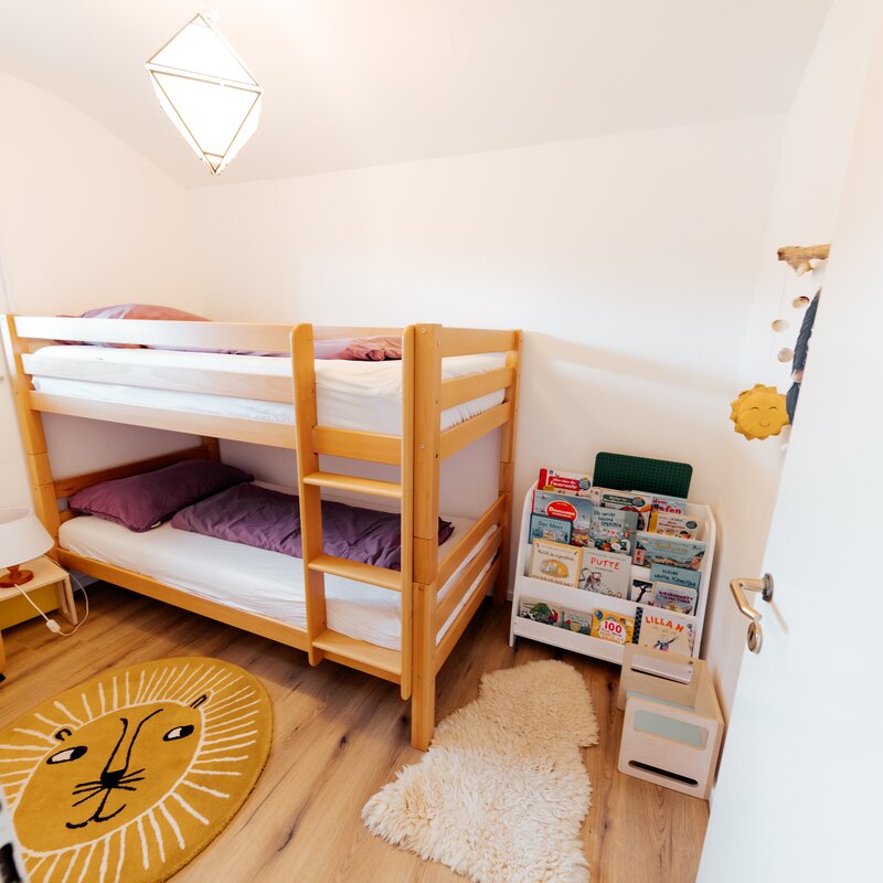 bunk bed for children with playing area and bookshelf