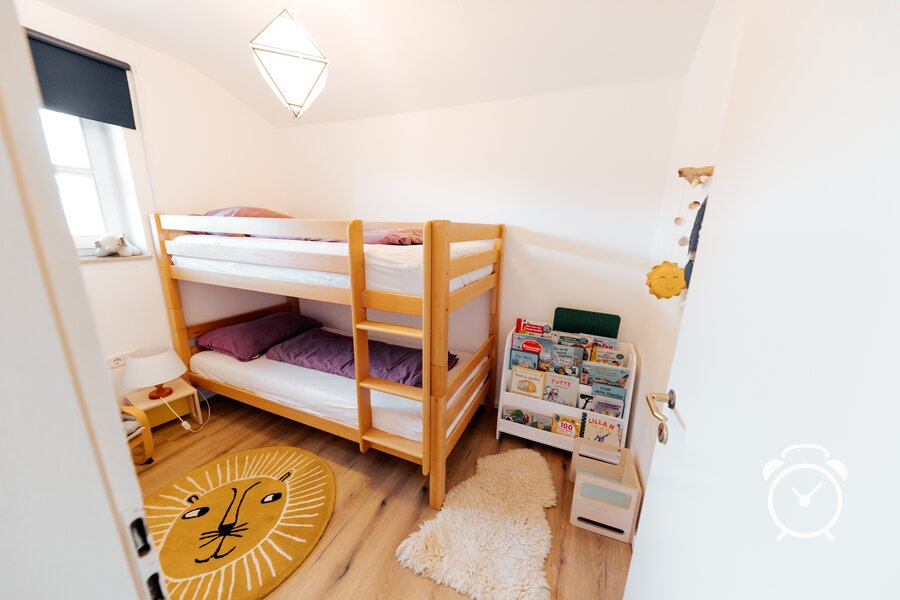 bunk bed for children with playing area and bookshelf