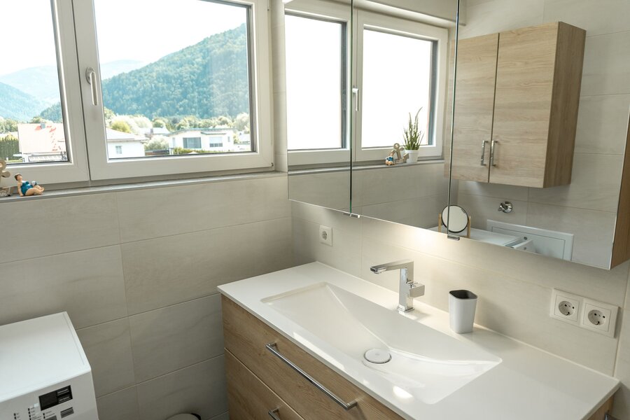 Bad mit Waschbecken, Spiegelschrank, Dusche und Waschmaschine