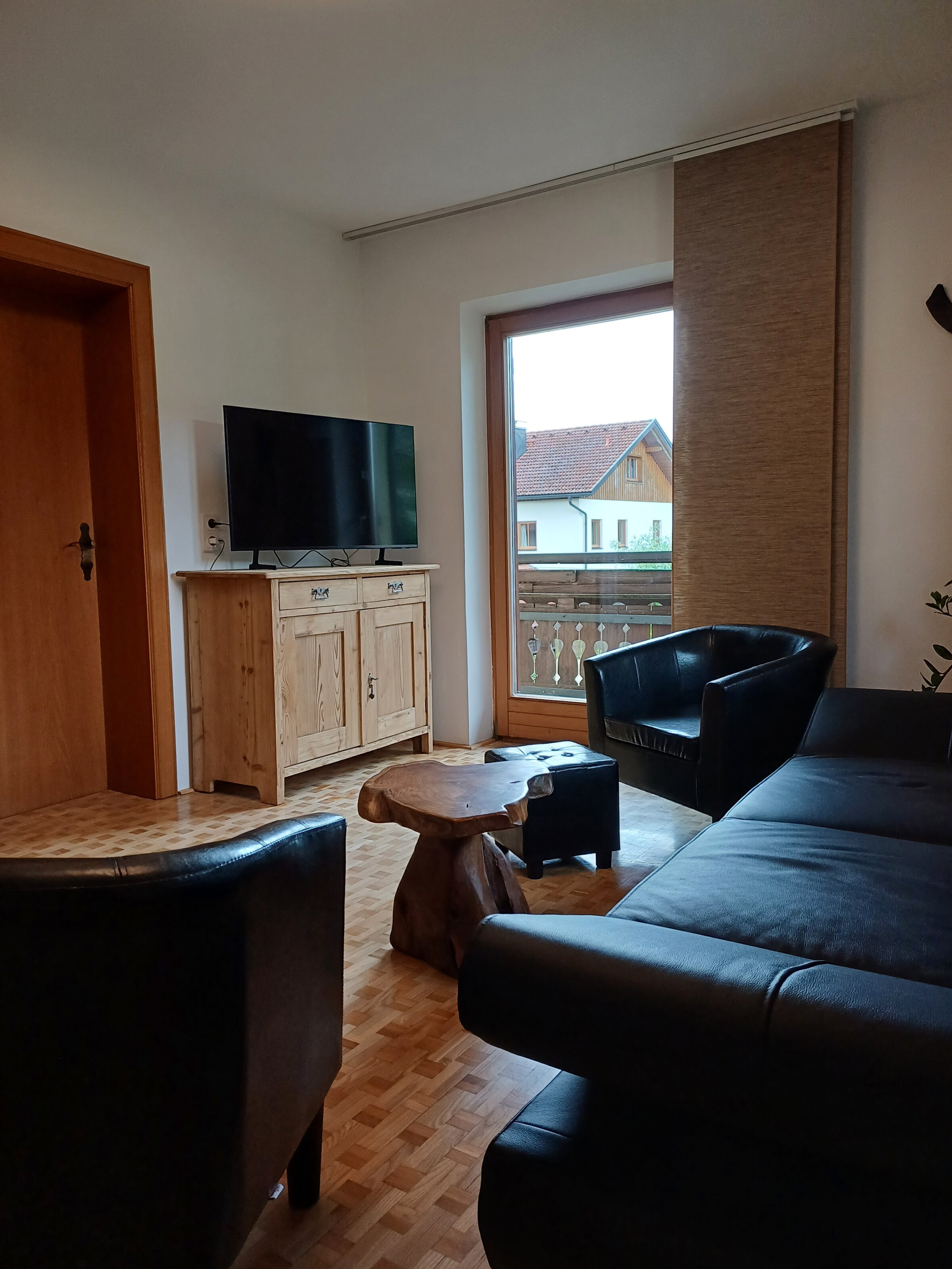 Wohnzimmer mit Ledersofa & TV – 3-Zimmer-Wohnung zur Kurzzeitmiete & Wohnen auf Zeit für 1 bis 6 Monate in Grödig