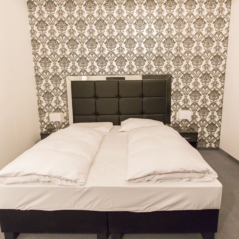 Neat double bed with white linen – 2-room apartment, short-term rental & temporary housing for 1 to 6 months in Vienna