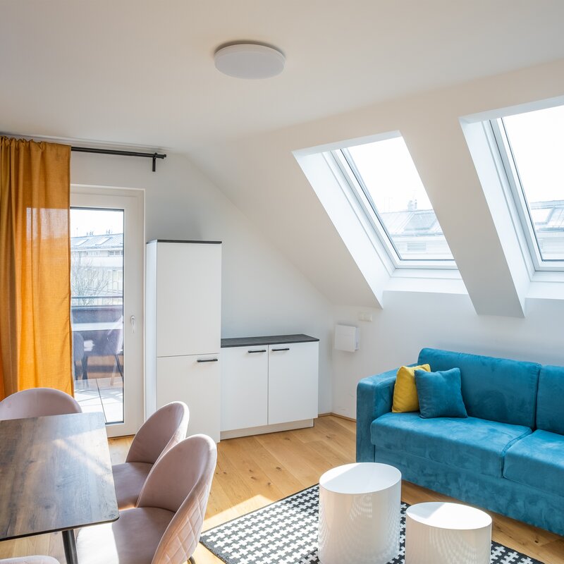Bright 2-room apartment with skylights & blue sofa – short-term rental & temporary housing for 1 to 6 months in Vienna