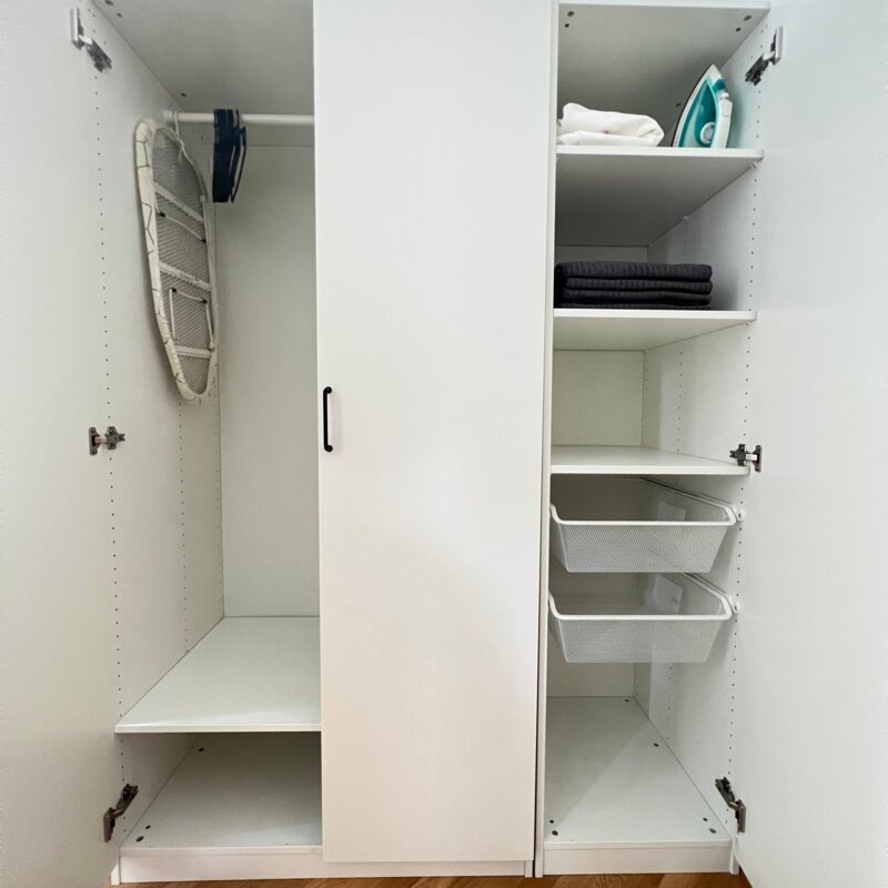 Spacious closet with towels, bed linen and iron