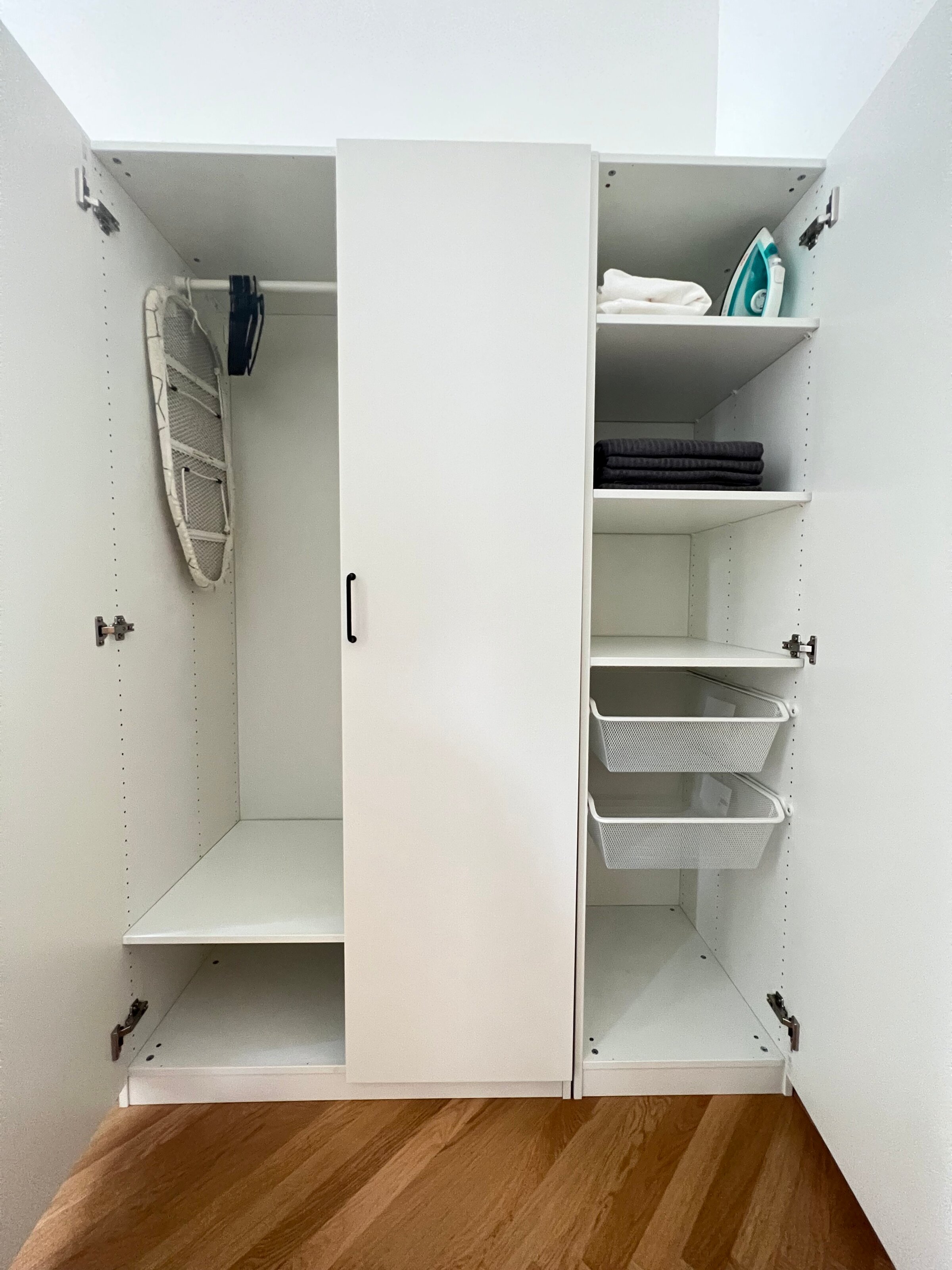 Spacious closet with towels, bed linen and iron
