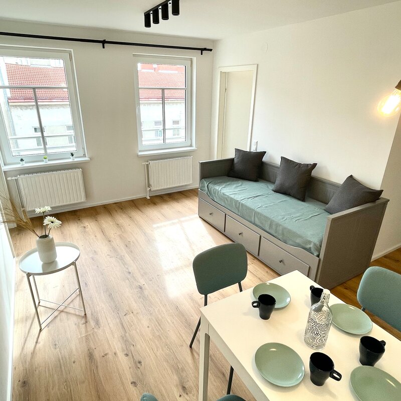 Living room with dining table and day bed (possibility as a double bed)