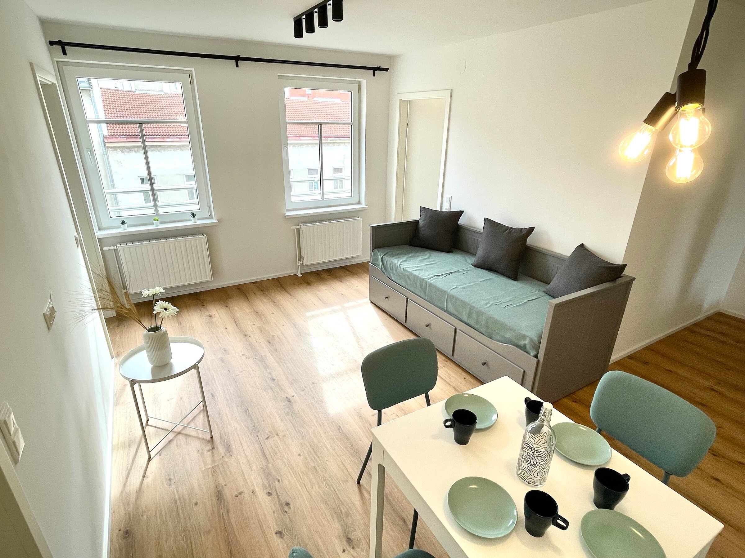 Living room with dining table and day bed (possibility as a double bed)