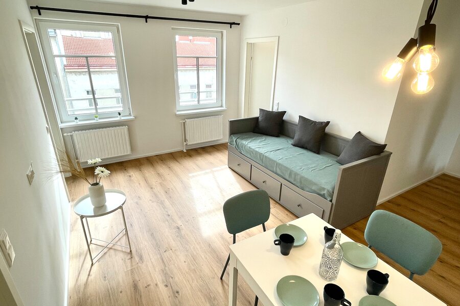 Living room with dining table and day bed (possibility as a double bed)