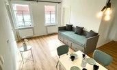Living room with dining table and day bed (possibility as a double bed)