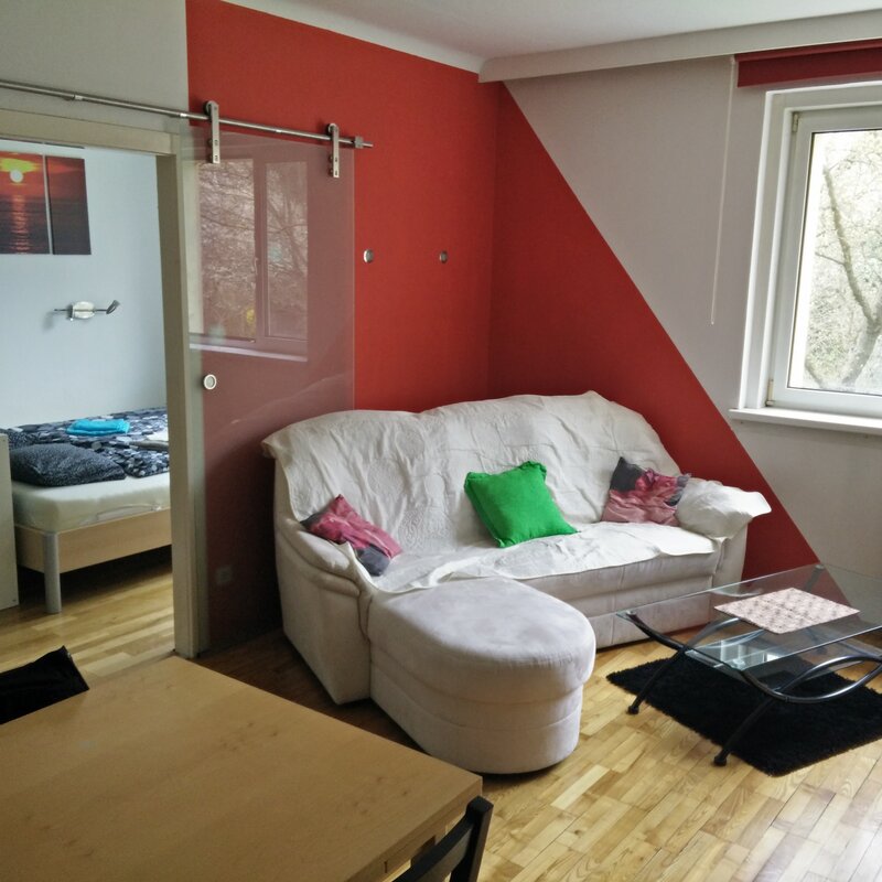 Bright living area with bedroom, sofa & parquet floor – 2-room apartment, short-term rental Vienna