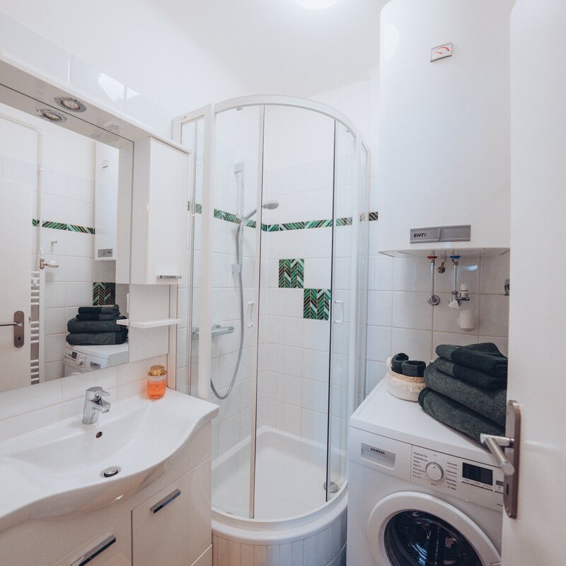 Bathroom with shower and washing machine | © Maier