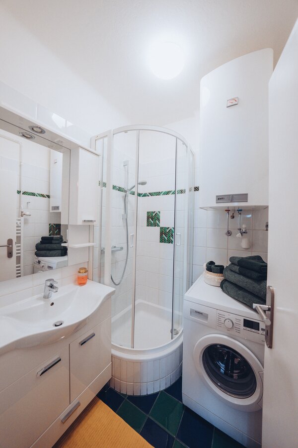 Bathroom with shower and washing machine | © Maier