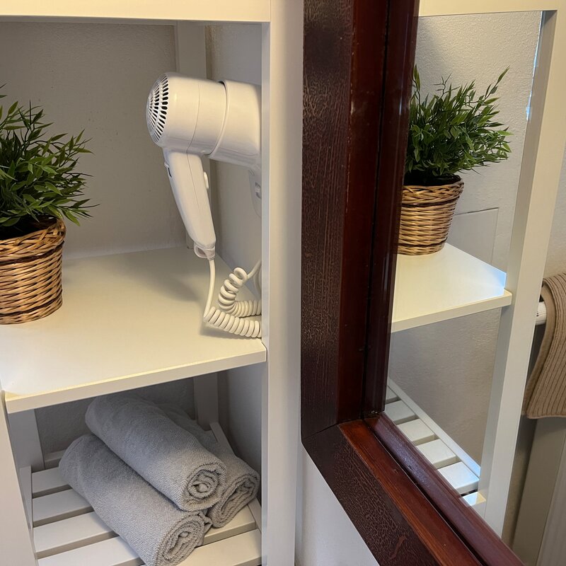 bathroom with hairdryer, towels and soap