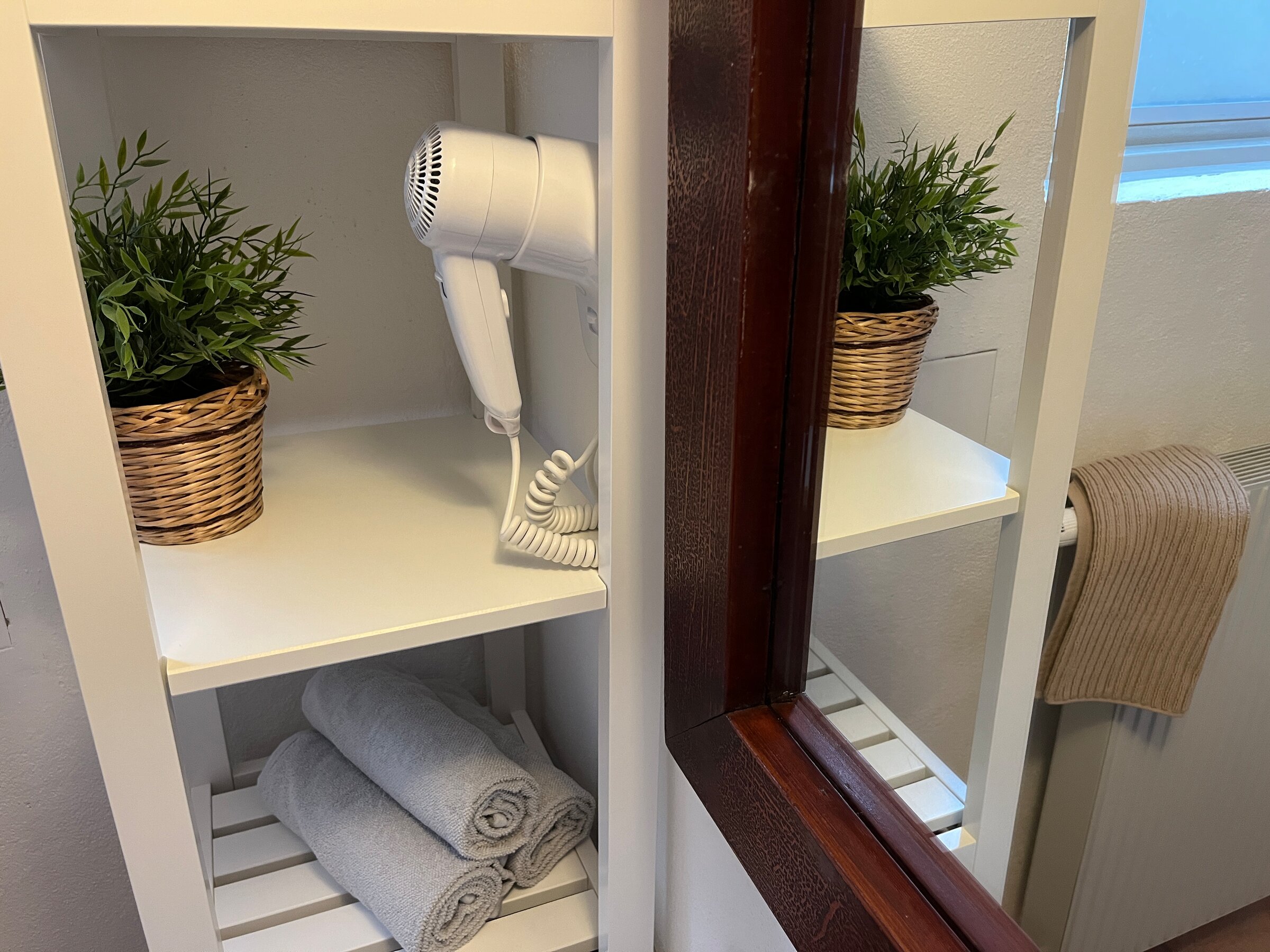bathroom with hairdryer, towels and soap