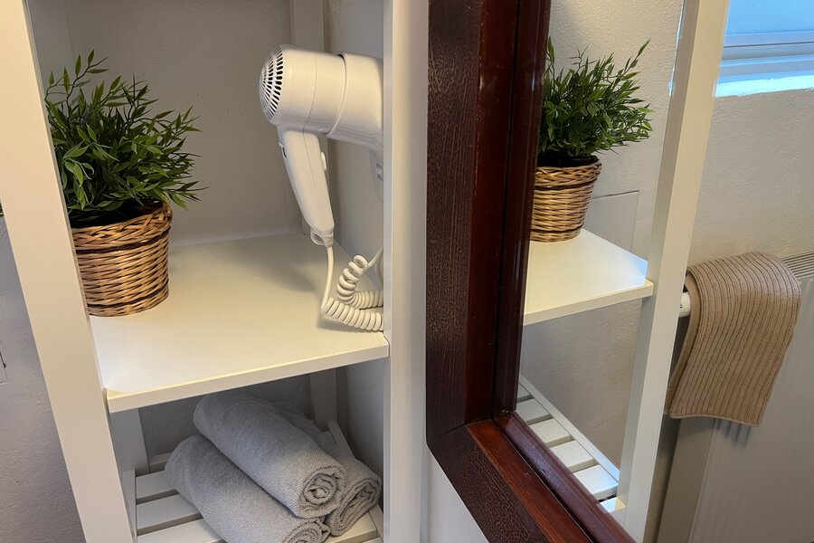 bathroom with hairdryer, towels and soap