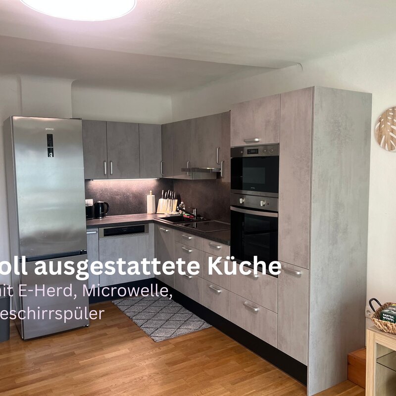 fully equipped kitchen with stove, microwave, dishwasher