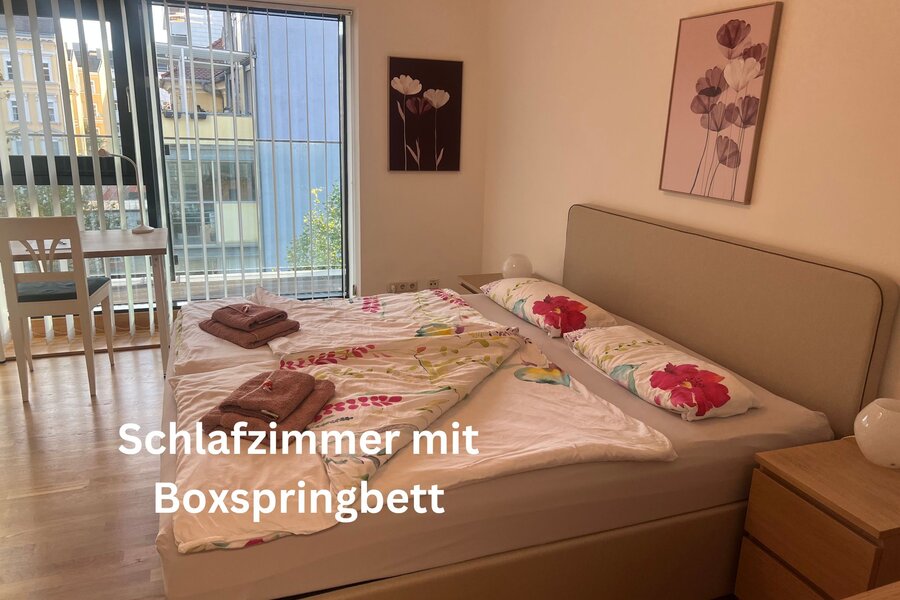 Bedroom with box spring bed