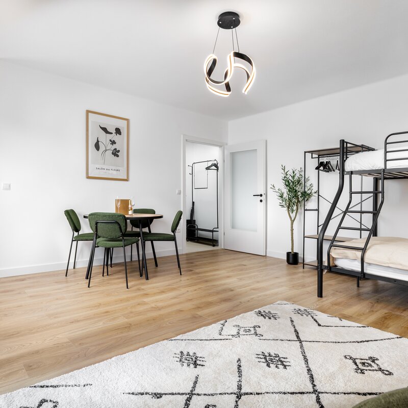 Living room with bunk bed and sofa bed as well as a dining area