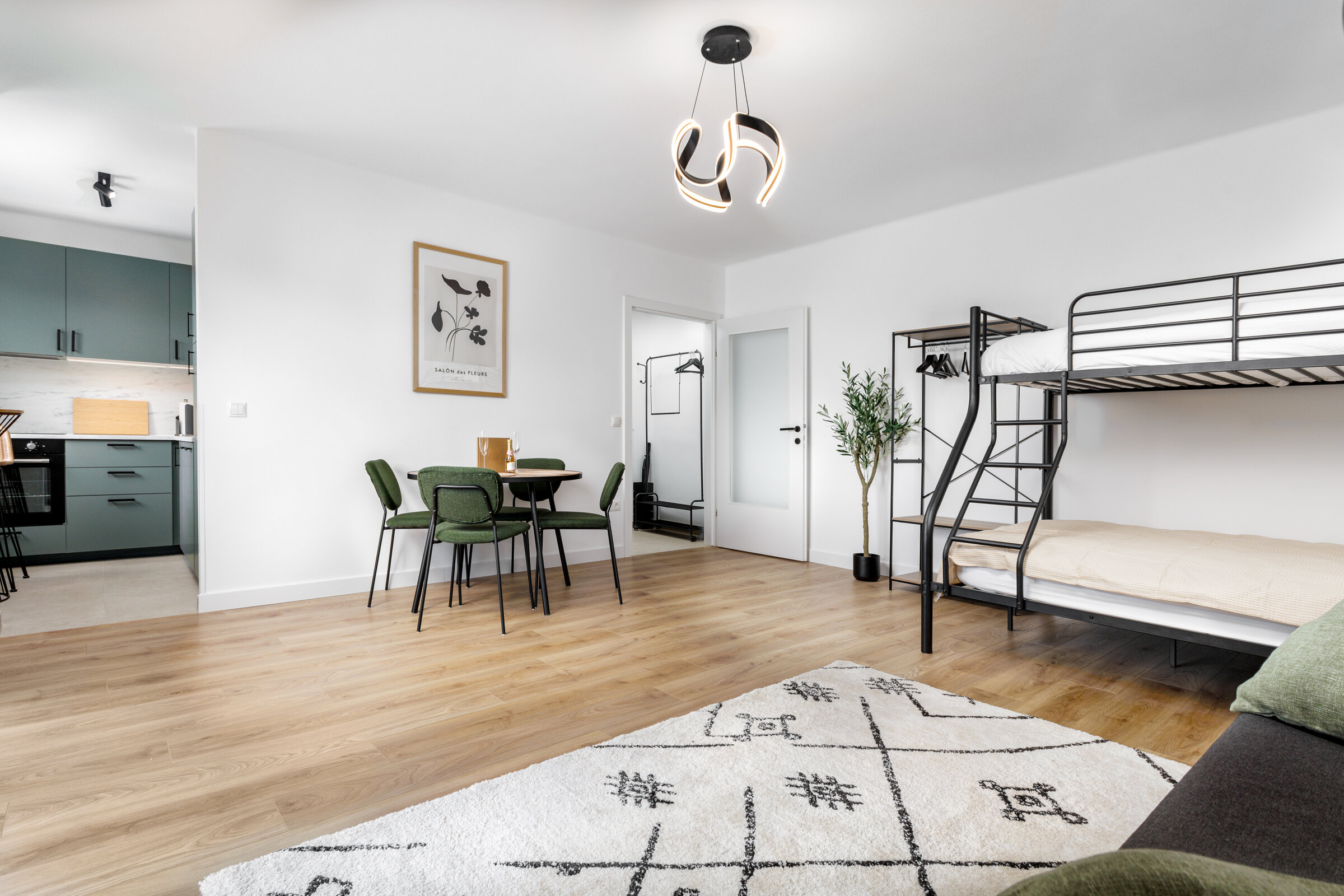 Living room with bunk bed and sofa bed as well as a dining area